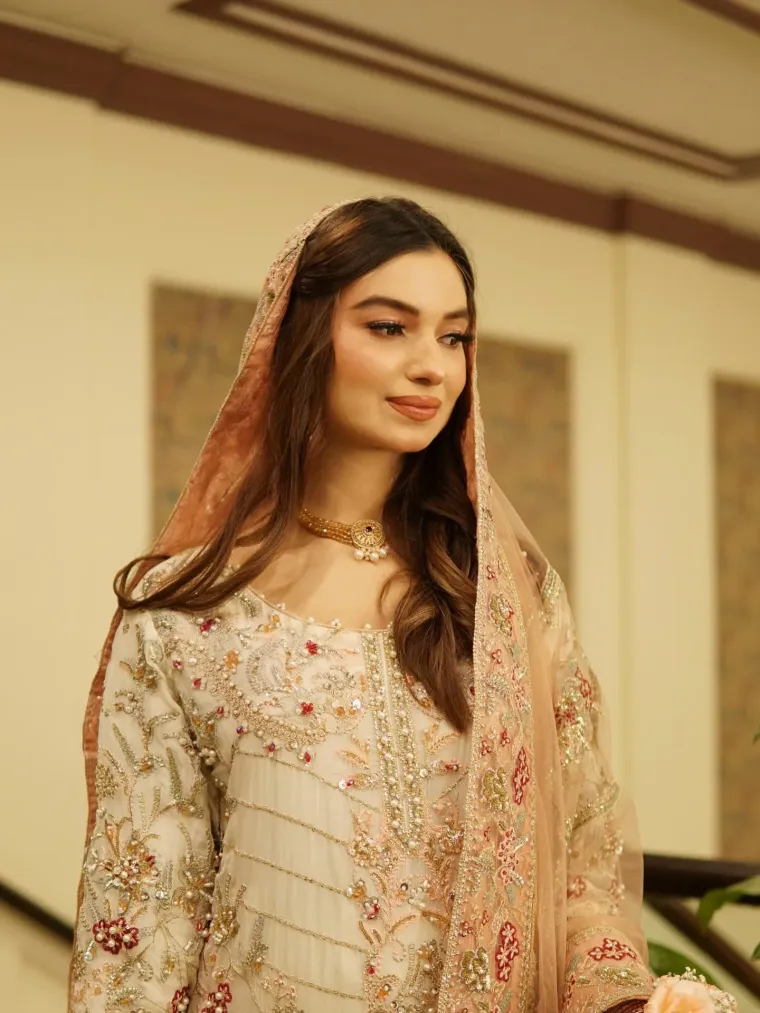 Bride in a pastel embroidered dupatta with dewy makeup by Blush Bar