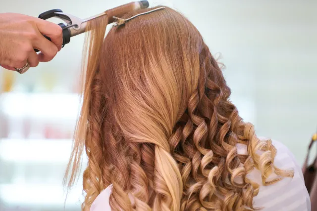 Stylist curling soft glam waves