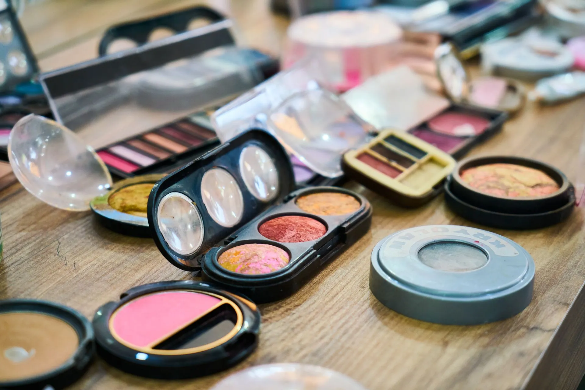Makeup products and brushes arranged on a table