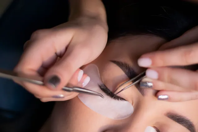 Lashes look — beautician applying extensions