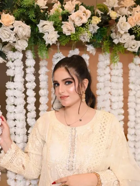 Soft smoky-eye makeup against a cream lace and floral backdrop