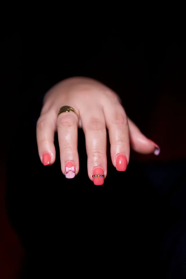 Pink manicure with a gold ring