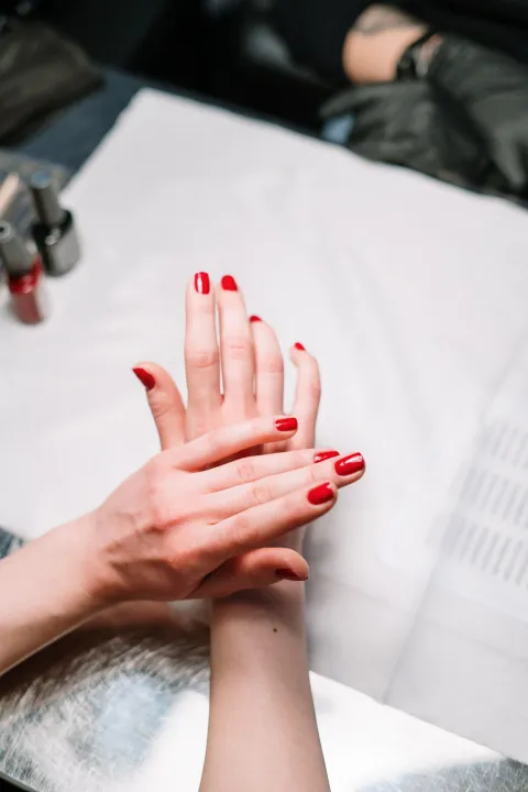 Fresh red gel polish in the nail studio